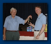 The winner smirking as he receives prize from Peter, G2HS